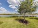 Lush lawn slopes to a tranquil lake view, offering a serene outdoor space at 177 Treviso Ct, North Venice, FL 34275