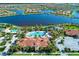 An aerial view of a community with a pool, clubhouse, and beautiful landscaping at 19124 Mangieri St, Venice, FL 34293