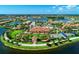 Aerial view showcasing the community clubhouse, pools, bocce ball and community landscaping at 19124 Mangieri St, Venice, FL 34293