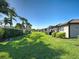 A beautifully maintained yard features lush green grass and manicured shrubbery at 19124 Mangieri St, Venice, FL 34293