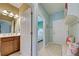 Bathroom view showing the vanity on the left, and in the distance, the mirror reflects the other bathroom door at 19124 Mangieri St, Venice, FL 34293