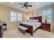 Cozy bedroom with plantation shutters, a ceiling fan and carpeted floors at 19124 Mangieri St, Venice, FL 34293