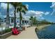 Elegant white clubhouse with waterfront access, framed by tall palm trees and well-maintained landscaping at 19124 Mangieri St, Venice, FL 34293