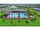 Aerial view of the community pool area, showcasing lush landscaping and ample lounge space at 19124 Mangieri St, Venice, FL 34293