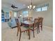 Dining room featuring wooden table, neutral tones, and views into the living area at 19124 Mangieri St, Venice, FL 34293