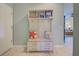 Inviting entryway featuring a cushioned bench, coat hooks, and storage shelves for added functionality at 19124 Mangieri St, Venice, FL 34293