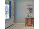 Elegant foyer with decorative glass front door, tile flooring, and a wooden console table with coastal decor at 19124 Mangieri St, Venice, FL 34293