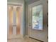 Foyer featuring tile floors, decorative glass door and a partially frosted glass door to the left at 19124 Mangieri St, Venice, FL 34293