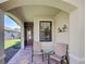 Inviting front porch with brick flooring, seating, and a decorative metal sculpture, creating a welcoming entrance at 19124 Mangieri St, Venice, FL 34293