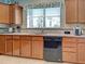 This kitchen features a window with a beautiful valance, granite countertops, and stainless steel appliances at 19124 Mangieri St, Venice, FL 34293