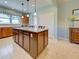 Open kitchen features a large center island with bar seating and wooden cabinetry at 19124 Mangieri St, Venice, FL 34293