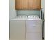 Functional laundry area equipped with a modern washer and dryer, plus convenient overhead storage at 19124 Mangieri St, Venice, FL 34293