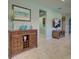 Cozy living room with hardwood floors, stylish console table, and a mounted television in the background at 19124 Mangieri St, Venice, FL 34293