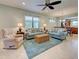 Spacious living room open to the dining area, with comfortable seating and stylish decor at 19124 Mangieri St, Venice, FL 34293