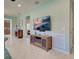 Living room with coastal decor, a console, and tiled floors at 19124 Mangieri St, Venice, FL 34293
