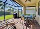 The screened patio includes comfortable seating, a ceiling fan, and a lovely view of the yard at 19124 Mangieri St, Venice, FL 34293