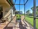 The screened patio features brick flooring and comfortable lounge chairs for relaxing outdoors at 19124 Mangieri St, Venice, FL 34293