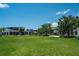 Lush green lawn with view of nearby shops and restaurants, creating a vibrant town center atmosphere at 19124 Mangieri St, Venice, FL 34293