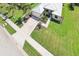 Aerial view of the front of home and neighborhood, showcasing manicured lawn and nearby street at 19893 Cobblestone Cir, Venice, FL 34292