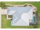 An aerial view of the home, showcasing the roofline, pool area, and surrounding landscape at 19893 Cobblestone Cir, Venice, FL 34292