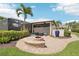 View of backyard firepit, landscaping, and screened lanai in a beautiful outdoor space at 19893 Cobblestone Cir, Venice, FL 34292