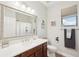 Bright bathroom featuring a horse-themed shower curtain, granite counters and a framed mirror at 19893 Cobblestone Cir, Venice, FL 34292