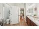 Bathroom with double vanity leading to bedroom and separate toilet area at 19893 Cobblestone Cir, Venice, FL 34292