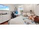 Bedroom with hardwood floors, chandelier, and a large TV mounted on the wall at 19893 Cobblestone Cir, Venice, FL 34292
