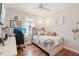 Comfortable bedroom with wood flooring, chandelier, and a window providing natural light at 19893 Cobblestone Cir, Venice, FL 34292