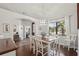 This dining room boasts hardwood floors, natural light, modern lighting, and open access to the living area at 19893 Cobblestone Cir, Venice, FL 34292