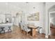 A dining room featuring modern lighting, table, and access to the kitchen and outdoor living space at 19893 Cobblestone Cir, Venice, FL 34292