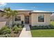 Close-up of a charming single-story home highlighting the beautifully landscaped front yard, and a covered entryway at 19893 Cobblestone Cir, Venice, FL 34292