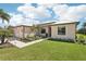 Attractive single-story home boasts a manicured lawn, lush landscaping, modern roof, and a convenient two-car garage at 19893 Cobblestone Cir, Venice, FL 34292