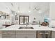 Stylish kitchen view including island seating, open to the living room and view to the outdoor living space at 19893 Cobblestone Cir, Venice, FL 34292
