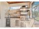 Close up of outdoor kitchen complete with grill, sink, and beverage cooler at 19893 Cobblestone Cir, Venice, FL 34292