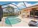 Inviting pool and patio with covered seating area, perfect for entertaining or relaxing at 19893 Cobblestone Cir, Venice, FL 34292