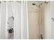 This shower features a white-tiled shower with a horse-themed shower curtain and a shower head at 19893 Cobblestone Cir, Venice, FL 34292
