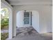 Covered entrance features stone flooring and decorative security door at 200 Sierra S St, Nokomis, FL 34275