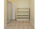 Hallway with tile flooring, open closet space, and built-in shelving unit for storage at 200 Sierra S St, Nokomis, FL 34275