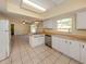 Open concept kitchen with stainless appliances, white cabinets, butcher block counters and tile flooring at 200 Sierra S St, Nokomis, FL 34275