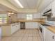 Kitchen has a stainless steel dishwasher and sink, butcher block counters and a tile backsplash at 200 Sierra S St, Nokomis, FL 34275