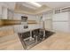 Kitchen has butcher block counters, white cabinets and appliances, and a stainless steel sink at 200 Sierra S St, Nokomis, FL 34275