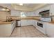 The kitchen features white cabinets and appliances, and a stainless steel dishwasher and sink at 200 Sierra S St, Nokomis, FL 34275
