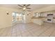 Living room adjacent to the kitchen has tile flooring, bay window and ceiling fan with light at 200 Sierra S St, Nokomis, FL 34275