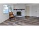 Bright living room with fireplace, chair and window at 200 Sierra S St, Nokomis, FL 34275