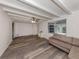 Spacious living room featuring wood floors, ceiling beams, and a ceiling fan at 200 Sierra S St, Nokomis, FL 34275