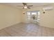 Living room has tile flooring, bay window and ceiling fan with wall mounted sconce lighting at 200 Sierra S St, Nokomis, FL 34275