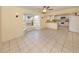 Living room adjacent to the kitchen has tile flooring, bay window and ceiling fan with light at 200 Sierra S St, Nokomis, FL 34275