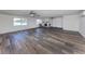 Open living room features brick fireplace, ceiling fans, and wood-look floors at 200 Sierra S St, Nokomis, FL 34275