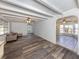 Spacious living room with hardwood floors leads to another room with tile flooring at 200 Sierra S St, Nokomis, FL 34275